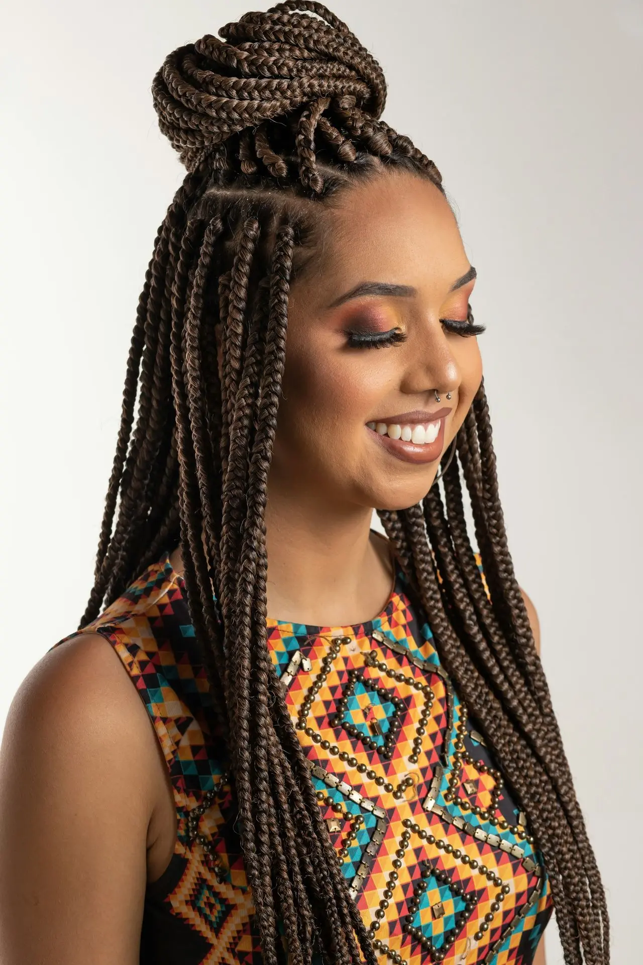 woman wearing multicolored blouse and braided hair